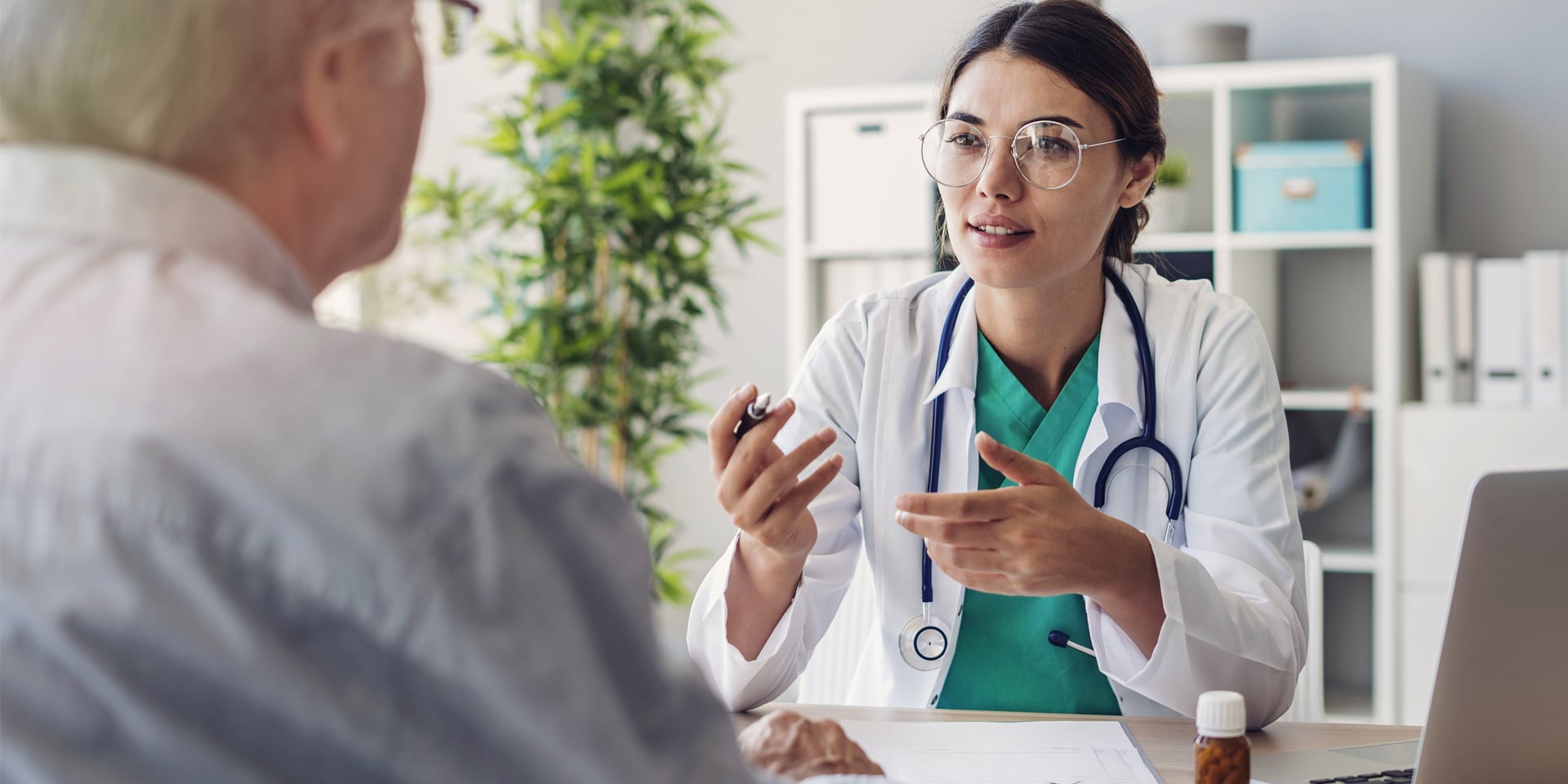 doctor at desk speaking to her patient