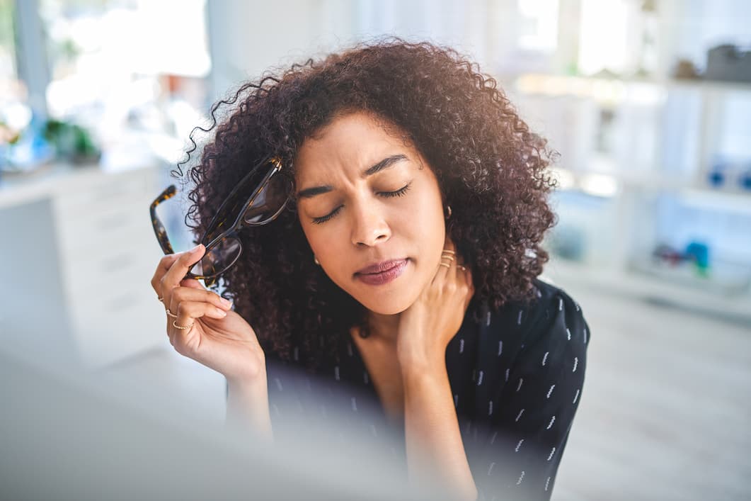 woman rubbing her neck