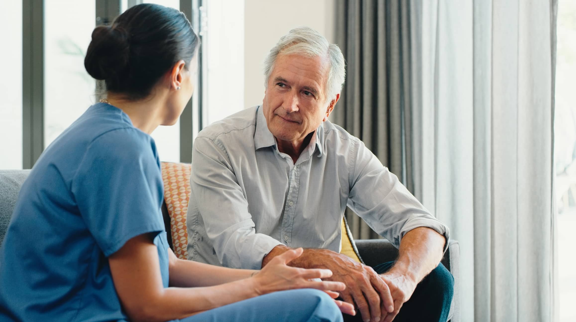 elderly man talking to doctor