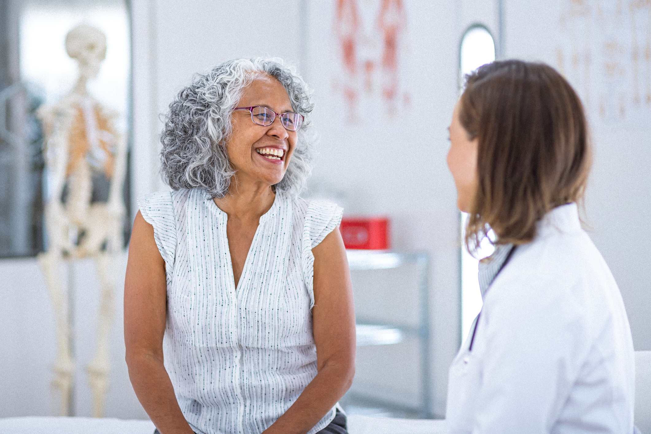 patient laughing with her doctor